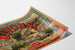 Vintage-Reiseplakat – Divonne — Familienaufenthalt am Genfersee, auf leicht gewölbtem Papier in perspektivischer Ansicht präsentiert