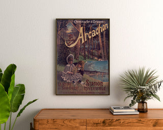 Vintage-Plakat Arcachon, Winterkurort, gerahmt über einer Holzkommode, zwischen Pflanzen.