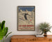 Vintage-Plakat Les Eaux-Bonnes, Wintersport, gerahmt über einer Holzkommode, zwischen Pflanzen.